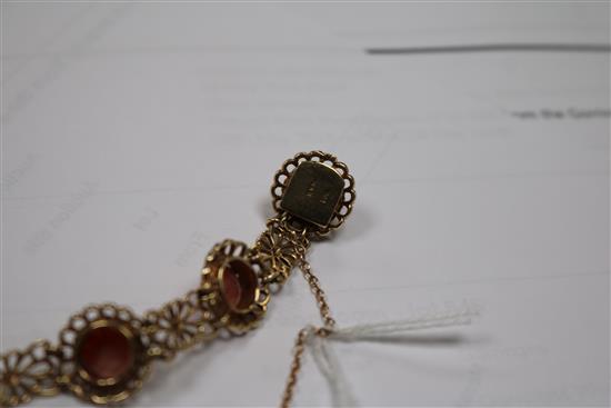 A 9ct gold and cabochon coral set pierced bracelet.